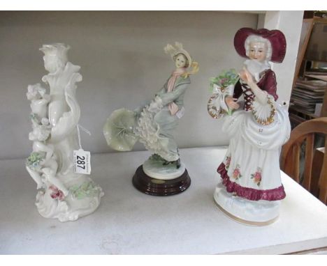 A cherub candlestick and 2 figurines