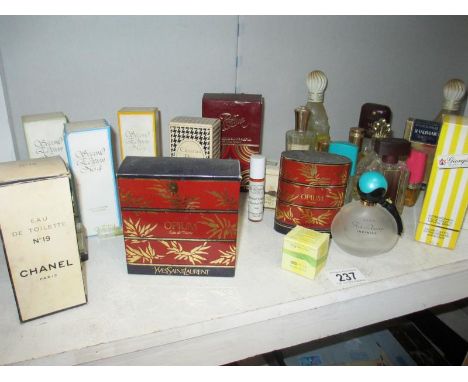 A shelf of perfume including some vintage, Chanel No.19, Opium, etc. some partly used