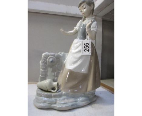 A Nao figurine of a girl dropping and breaking a water jug (a/f missing fingers on one hand)