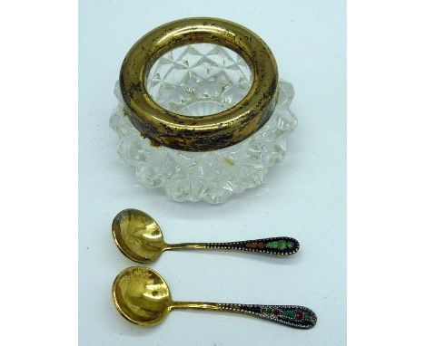 A silver rimmed salt and two silver and enamel salt spoons