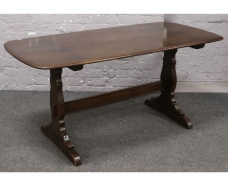 An Ercol dark oak refectory table, 153cm x 77cm. 