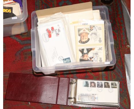 A box of first day covers to include albums and loose examples. 