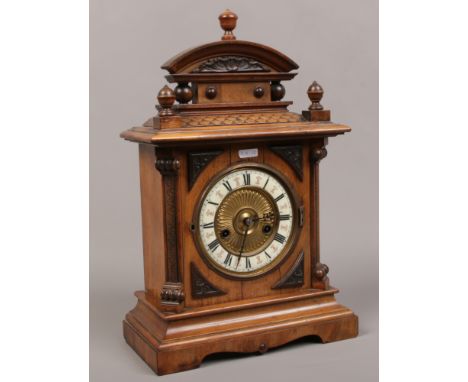 A Victorian carved walnut eight day mantle clock half hour chime / hour gong. 