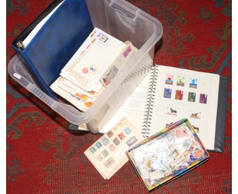 A box lot of stamp albums and loose stamps from around the world and American first day covers. 