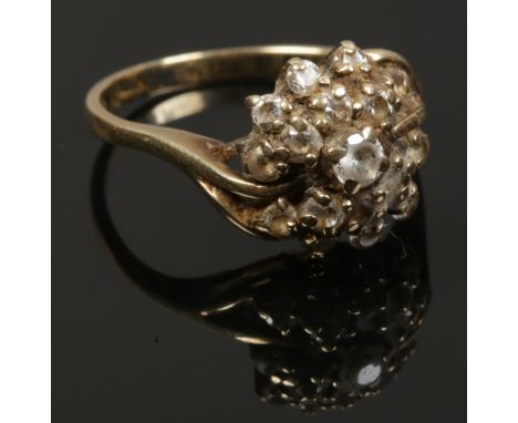 A ladies 9ct gold floriform ring set with white paste stones, size K 3.06 grams. 