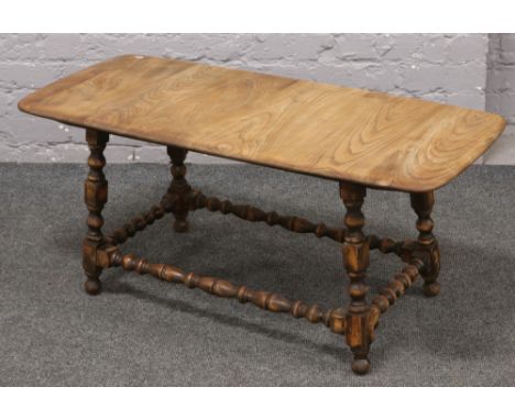An Ercol style coffee table with turned supports. 