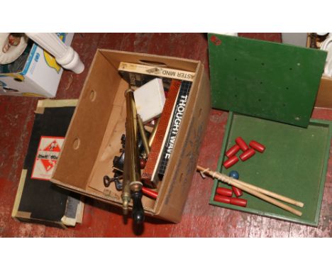 A box of vintage games and assorted metalwares including stirrup pumps and a mincer. 