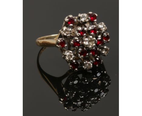 An 18ct gold diamond and ruby cluster ring, size J. 