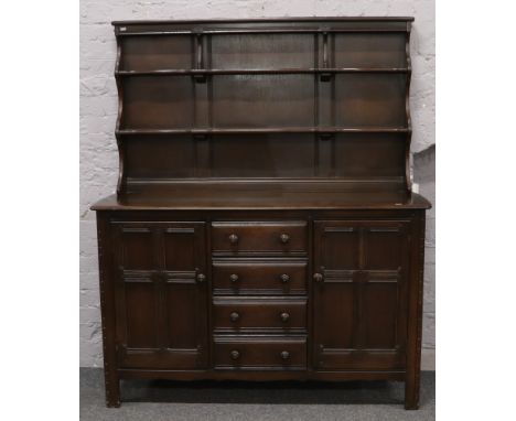An Ercol dark oak Welsh dresser, 170cm tall x 147cm wide x 51cm deep. 