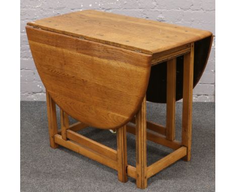 A light oak gate leg drop leaf table. 