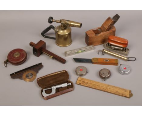 A box of metalwares and wooden items including universal and angle level, salter scales, The Boudoir travelling iron and vari