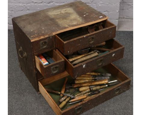 A portable vintage pine cabinet makers tool chest of six drawers and contents of tenon saws, brace set squares, joiners scrib