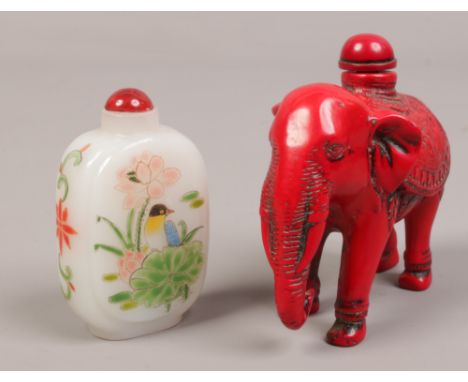 An oriental carved composite snuff bottle formed as an elephant, along with a hand painted glass snuff box decorated with bir