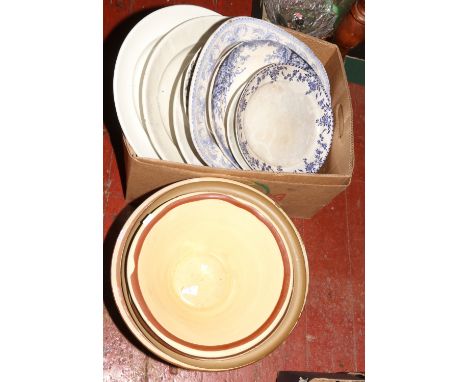 A box of large ceramic meat plates and four pancheons. 
