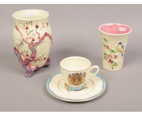 A Clarice Cliff vase, along with a Clarice Cliff commemorative cup and saucer and another vase. 