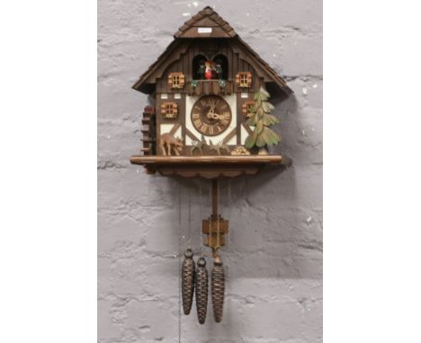 A German Schneider triple weight cuckoo clock with Edelweiss tune. 