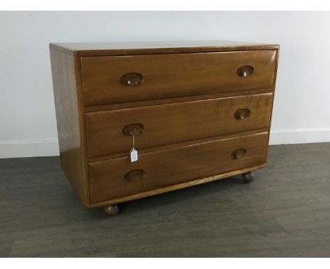 ERCOL, PAIR OF WINDSOR MODEL 484 ELM CHESTS OF DRAWERS CIRCA 1960-69 each fitted with three drawers, on castors, retaining bl