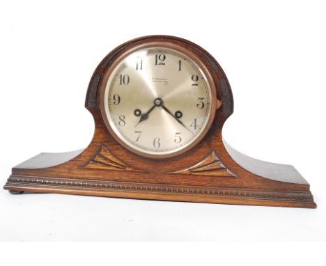A 1900's oak cased napoleons hat mantel clock having 8 day movement with silvered dial bearing notation for A Wernet, Newport