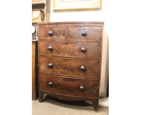 A 19th century Georgian bow front bachelors chest of drawers. Raised on bracket feet having 2 short drawers over deep drawers