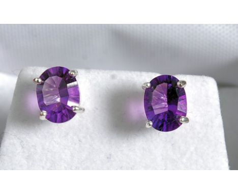 A pair of silver and amethyst earrings