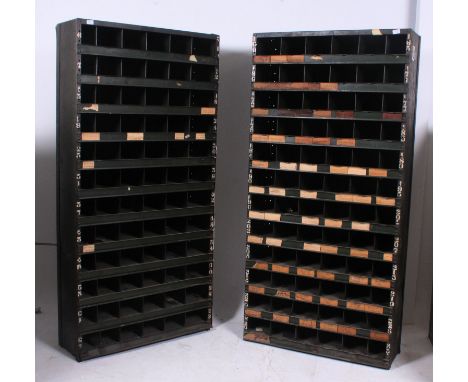 A pair of  original mid 20th century Industrial large green enamel metal sectional cubby cabinet. The cabinets each having 72