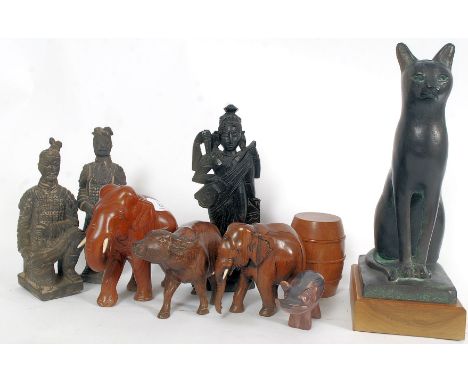 A collection of wooden animals to include ox, elephant, hippo. To also include Egyptian cat ornament, wooden thai deity and c