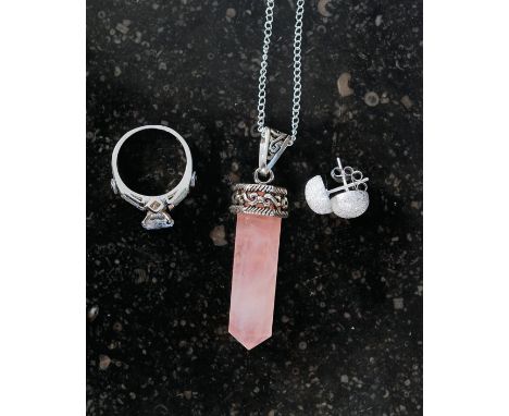 A silver and CZ dress ring together with a rose quartz pendant necklace and a pair of Cartier style ball earings