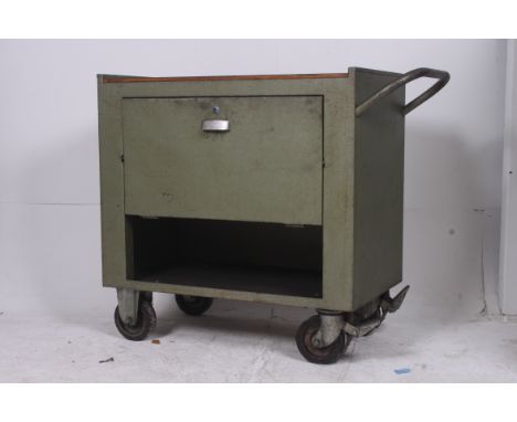 A good 1950's mid 20th century Industrial trolley raised on large castors. The enamel painted metal body with large fall fron