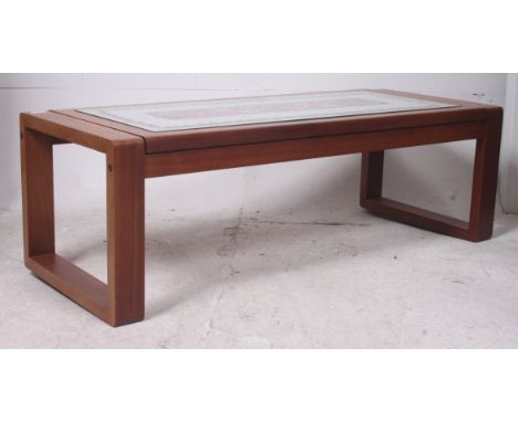 A 1970's teak and tile top retro coffee / occasional table having inset tiles to the rectangular body above