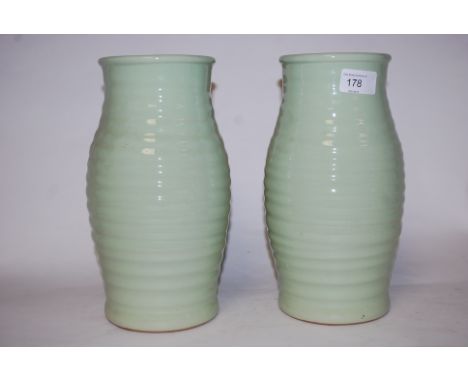 A pair of large Bourne Denby ceramic celadon ribbed vases. The large bulbous bodies being ribbed to centre, stamped to base f