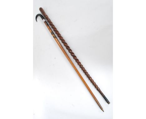 A Victorian twist walking stick cane along with an early 20th century alpine walking stick with badges