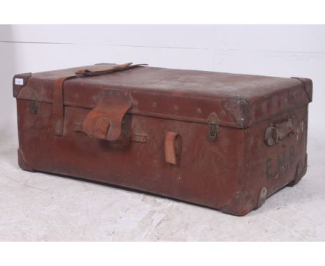An early 20th century  large leather suitcase / steamer trunk with monograme E.M.B. on the side having leather panels with cl