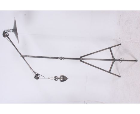 A mid 20th century polished steel surveyors pulley tripod lamp. The fabulous tripod rising through to a UFO style pendant sha