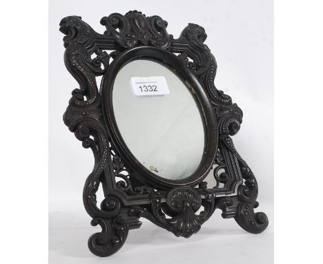 A late 19th century  bois durci easel dressing table mirror. Inset with an oval mirror having a stunning lion mask and cornuc