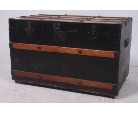 A good 19th century wooden bound trunk having ebonised canvas body, wooden strapping with good clasps to front. The interior 