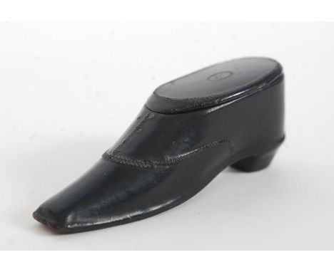 A 19th century Victorian papier mache snuff box in the form of a shoe. Ebonised with hinged top.