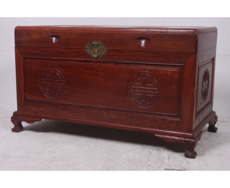 A 20th century Chinese hardwood trunk / blanket box. Raised on shaped legs with carved details having hinged top above. Measu