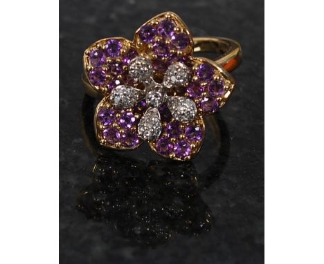 A 9ct gold diamond and amethyst flower head ring set on simple form hoop being hallmarked to the inside. Weight 5,4 grams. O 