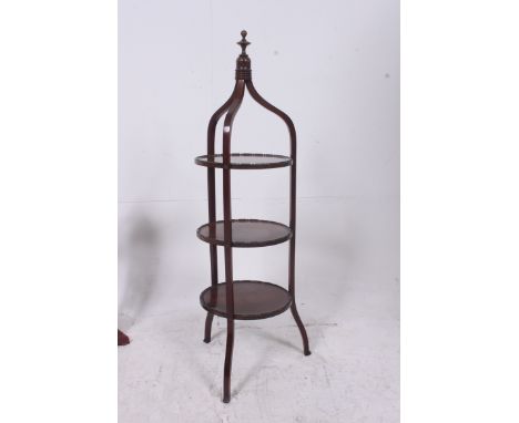 An Edwardian mahogany 3 tier bell top cake stand having circular tiers with finial atop, all raised on shaped supports. Measu