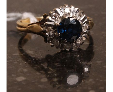 An 18k gold sapphire and diamond ring. Weight 5g.