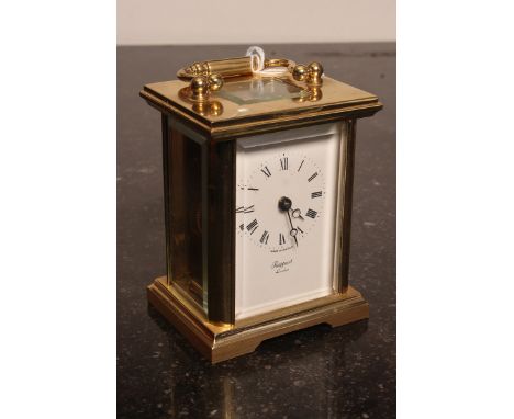 A 20th century Rapport of London brass carriage clock. The open escapement with glass viewing panel top and sides. , the move