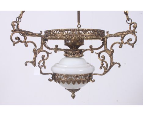A good gilt metal rococo chandelier having milk glass shade and oil lamp base with bar arms and chain to top