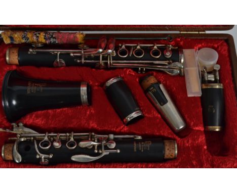 A Boosey and Hawkes Emporer Clarinet complete with the case having velvet lined interior and some accessories