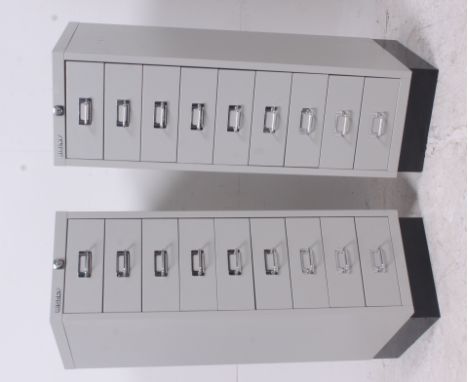 A pair of 1970's light grey enamel painted metal industrial pedestal filing cabinets by Bisley. Each drawers with notation sl