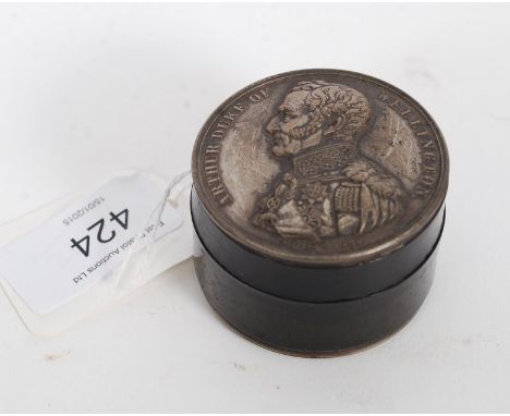 A 20th century treen snuff box with coin to the lid