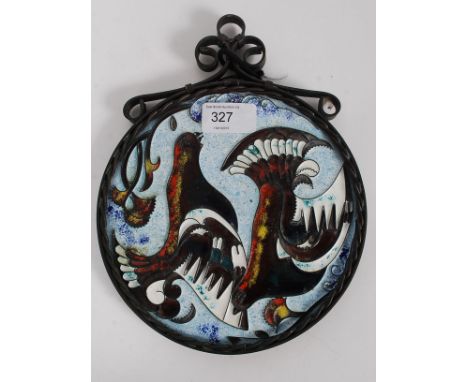 A 20th century decorated enamel painted plaque with scenes of doves all set within a copper surround