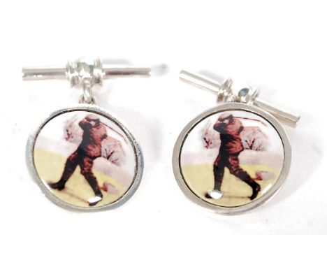 A pair of silver and enamel cufflinks depicting a golfer