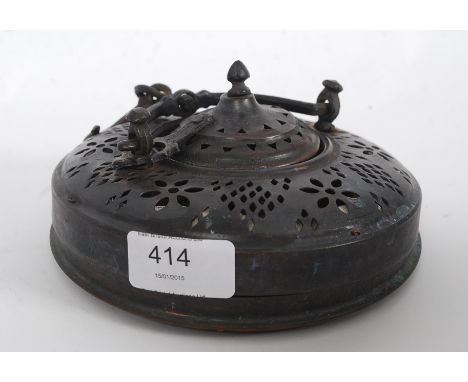 An early 20th century Arabic copper and canvas hanging lantern having pierced top with candle sconce to interior. Measures 40