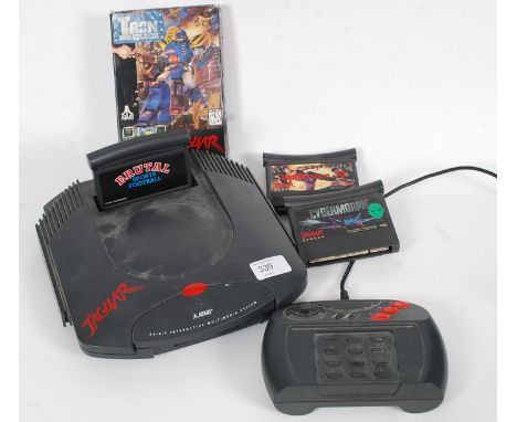 A vintage Atari Jaguar games console, circa 1993 to include games, Iron Soldier, Wolfenstein 3d, Brutal Football and others e