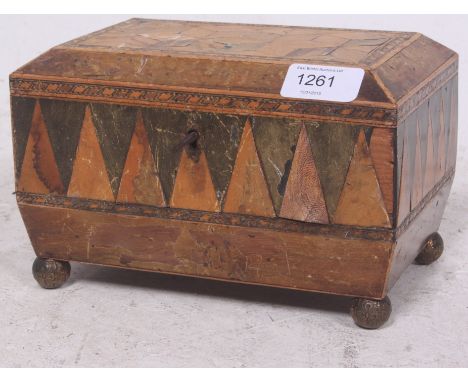 A 19th century brass footed specimen inlaid sarcophagus tea caddy having hinged top with twin sections within